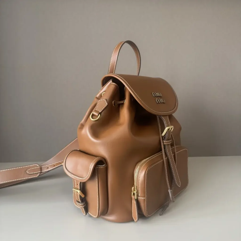 Miu Miu Backpack small brown leather bag with buckle and zippered pockets