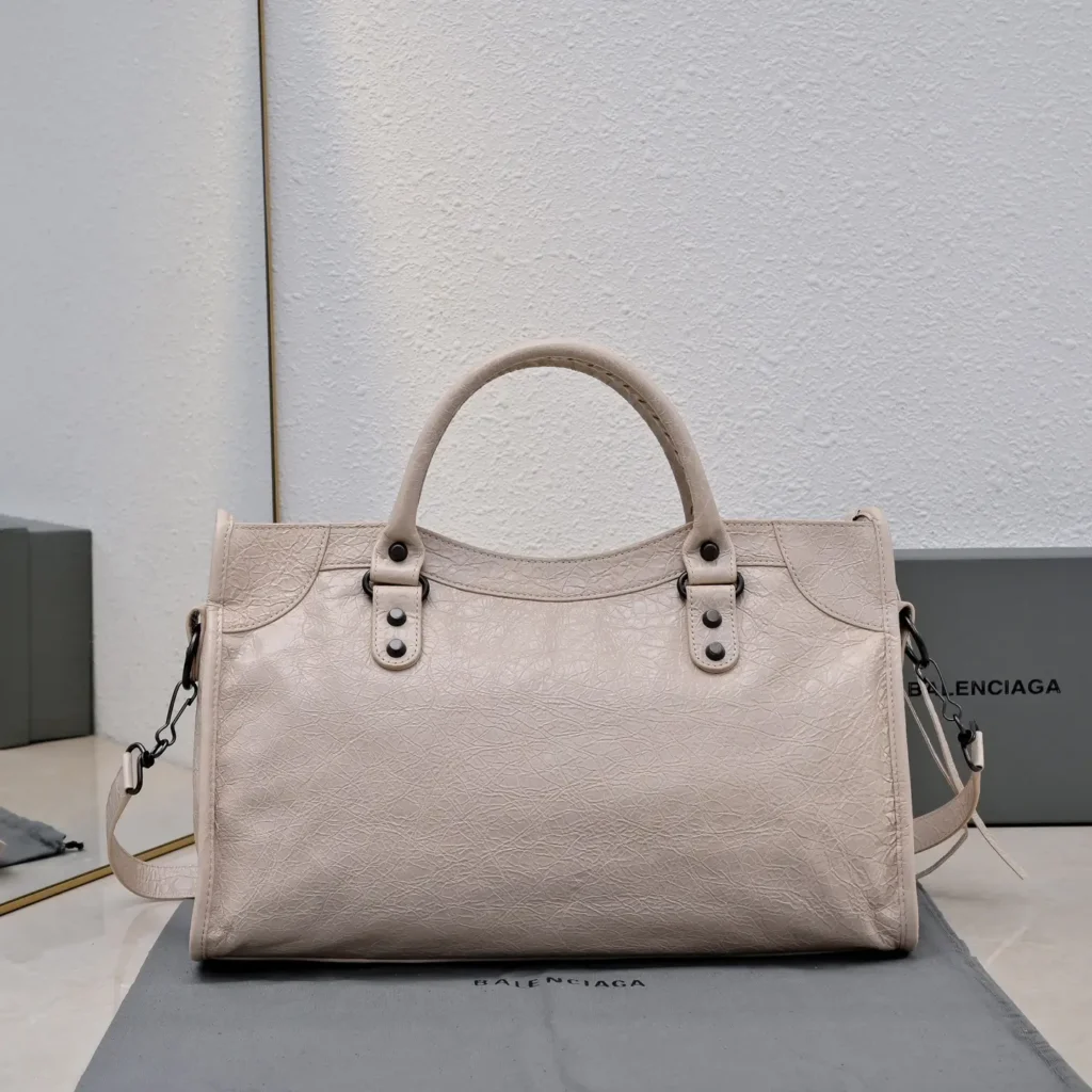 Balenciaga Classic City bag medium textured leather in light beige with top handles and detachable shoulder strap