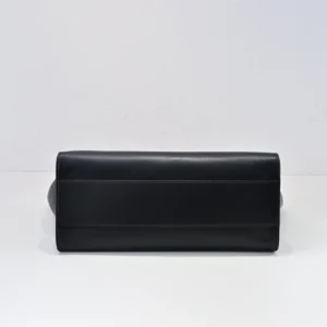 Black The Row Marlo Tote bag showcasing saddle leather design and spacious interior, emphasizing casual style and durability.