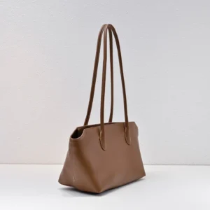 Saddle leather shoulder bag in brown with long straps, showcasing a sleek design and ample capacity, suitable for commuting and stylish use.