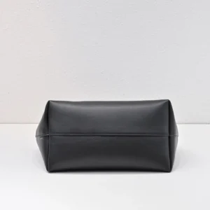 Black leather handbag with a sleek design and structured shape, showcasing the rich texture of calf leather, featured in The Row Saddle Leather Black Silver Buckle product listing.