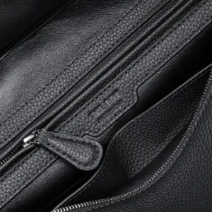 The Row small black leather handbag with zippered interior pocket and smooth grain texture