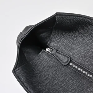 Given the image shows a close-up of the inside of a black textured leather bag with a zipper, but no visible brand, model, or size, I will create a general alt text example for a bag. Example alt text: "Generic black leather bag interior with silver zipper and textured material finish" If you provide brand, model, or size details, I can customize it accordingly.