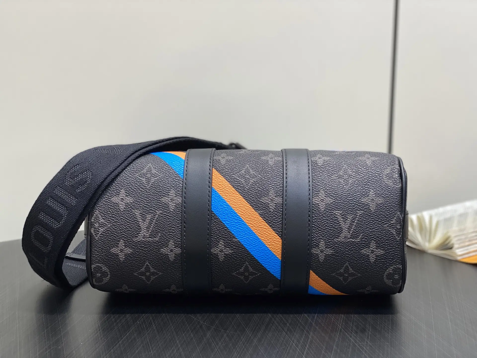 Louis Vuitton Keepall 50 M45558 black monogram canvas bag with blue and orange stripes and leather straps
