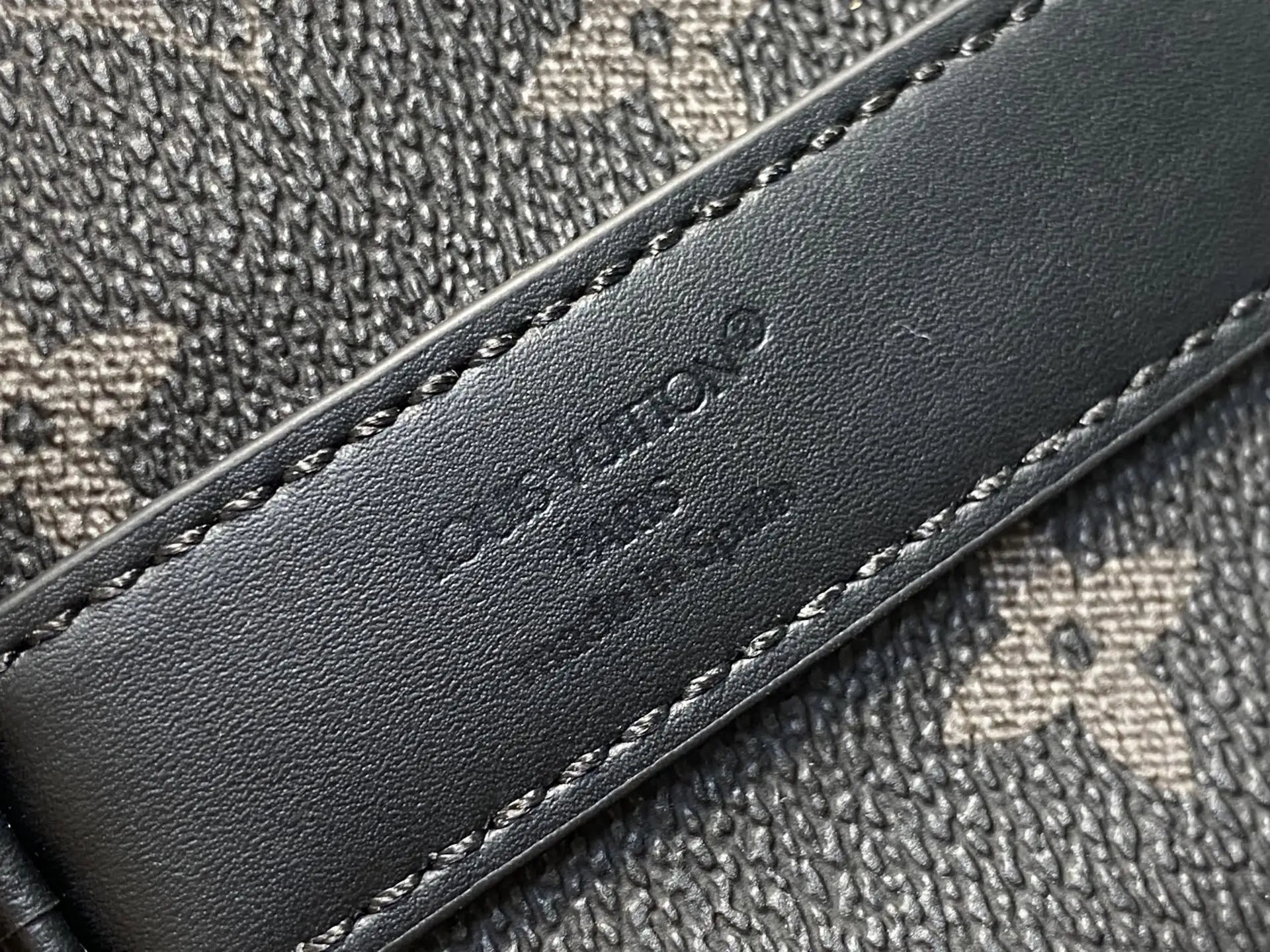 Louis Vuitton monogram canvas leather strap black leather trim stitching close-up detail
