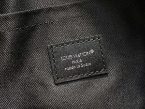 Louis Vuitton product tag black leather label made in Spain on textured fabric lining
