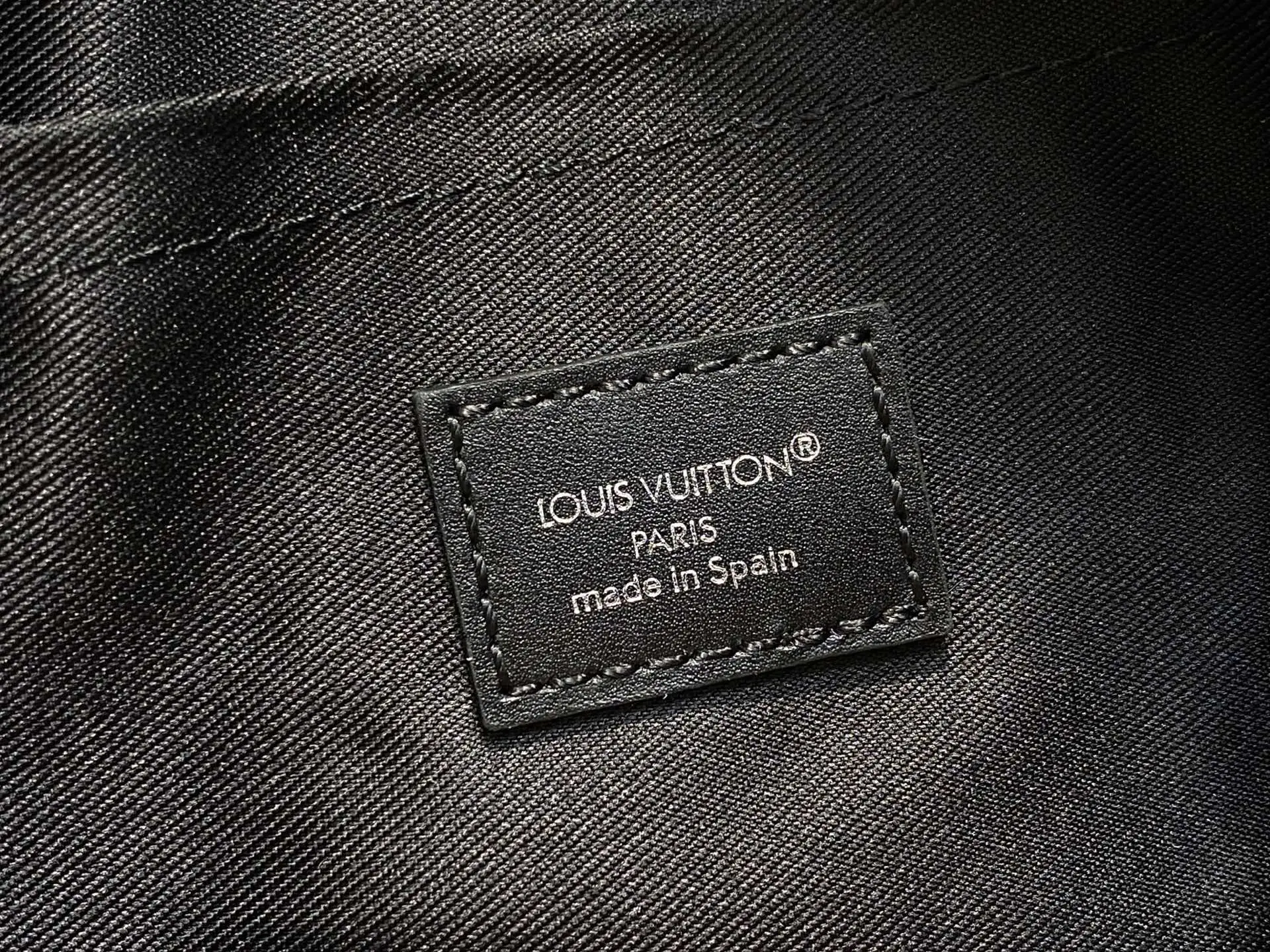 Louis Vuitton product tag black leather label made in Spain on textured fabric lining