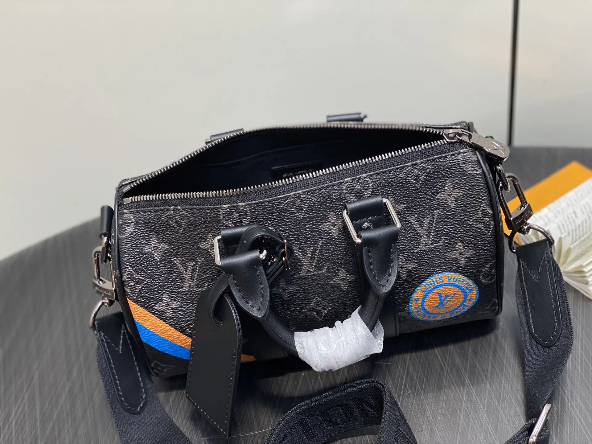Louis Vuitton Keepall 55 M41414 black monogram canvas duffle bag with blue and orange stripe leather accents