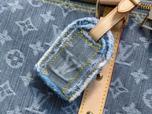 Louis Vuitton Tag denim monogram canvas bag detail with beige leather strap and yellow stitching