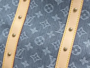 Louis Vuitton denim monogram canvas bag with natural leather straps and gold-tone studs