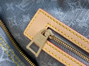 Louis Vuitton zipper pull on monogram canvas bag with beige leather trim and yellow stitching detailing
