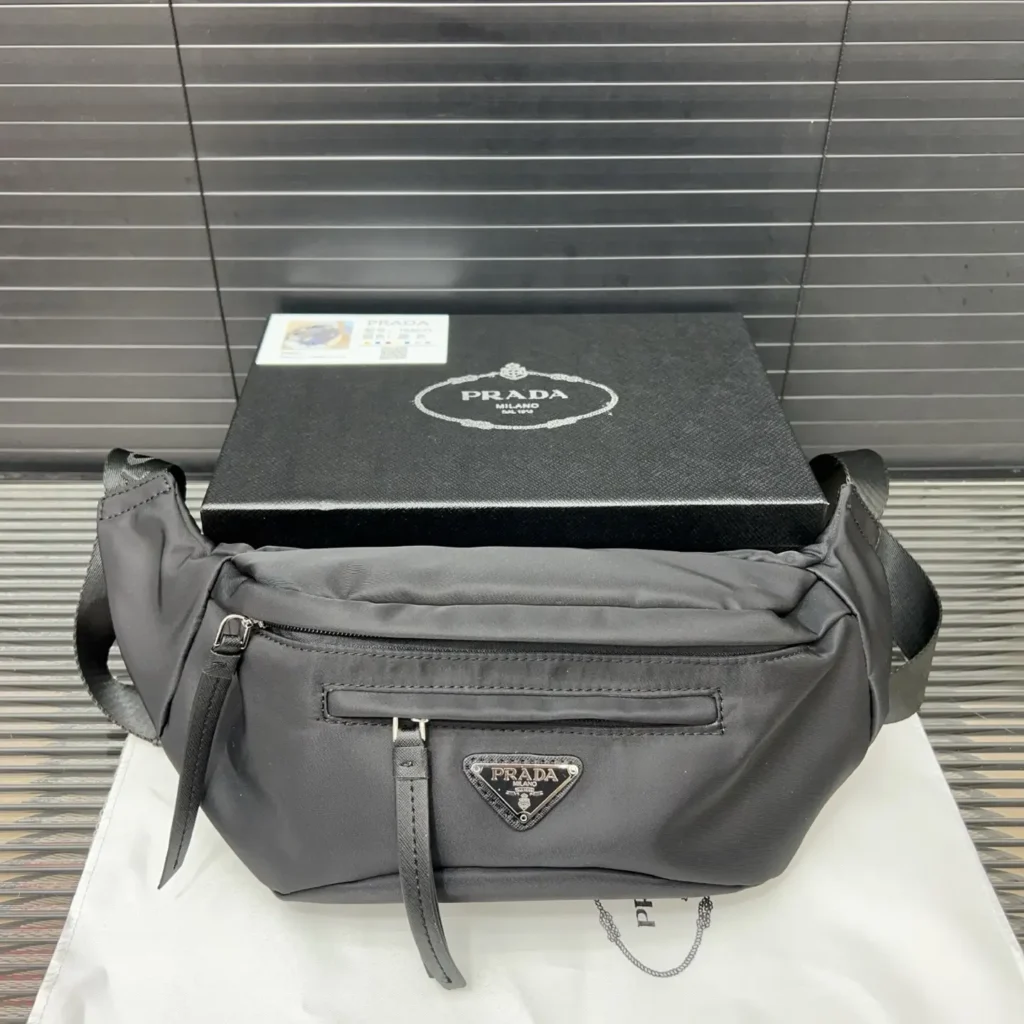 Prada Re-Edition 2005 1BL010 black nylon waist bag with leather zipper pulls and logo plaque