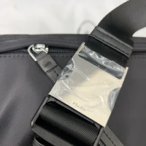 Prada nylon cloth waist bag strap detail with logo tag and zipper, showcasing high-quality replica design.