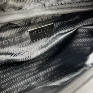 Prada nylon cloth waist bag interior showcasing logo and fabric pattern, emphasizing luxury design and quality.