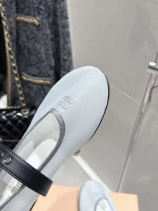 Miu Miu Hollow Weaving Ballet Shoe with soft mesh fabric and black strap detail, showcasing luxury footwear design.