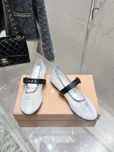 Miu Miu Hollow Weaving Ballet Shoes displayed on a box, featuring a soft mesh upper and a black strap, emphasizing luxury and feminine design.