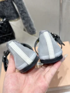 Miu Miu Hollow Weaving Ballet Shoes showcased from the back, highlighting the soft mesh fabric and contrasting white stripe detail, emphasizing luxury and feminine design.