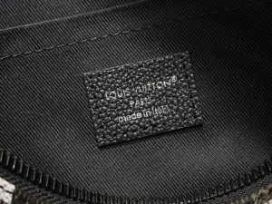 Louis Vuitton bag interior black textured leather label made in Italy close-up inside textile lining
