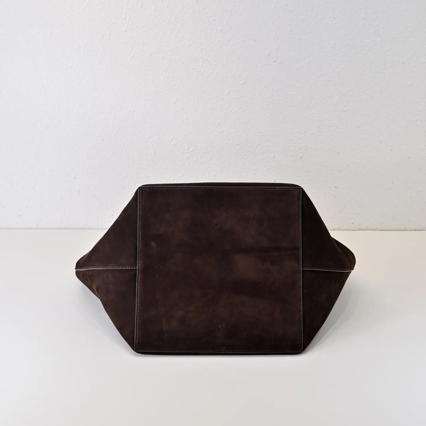 Given the image shows a dark brown leather bag viewed from its base, additional details like brand, model, size, and style ID are required to generate the SEO-optimized alt text as per your rules. Could you please provide those details?