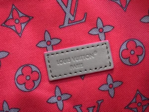 Louis Vuitton bag red monogram canvas gray leather logo patch detailed fabric close-up
