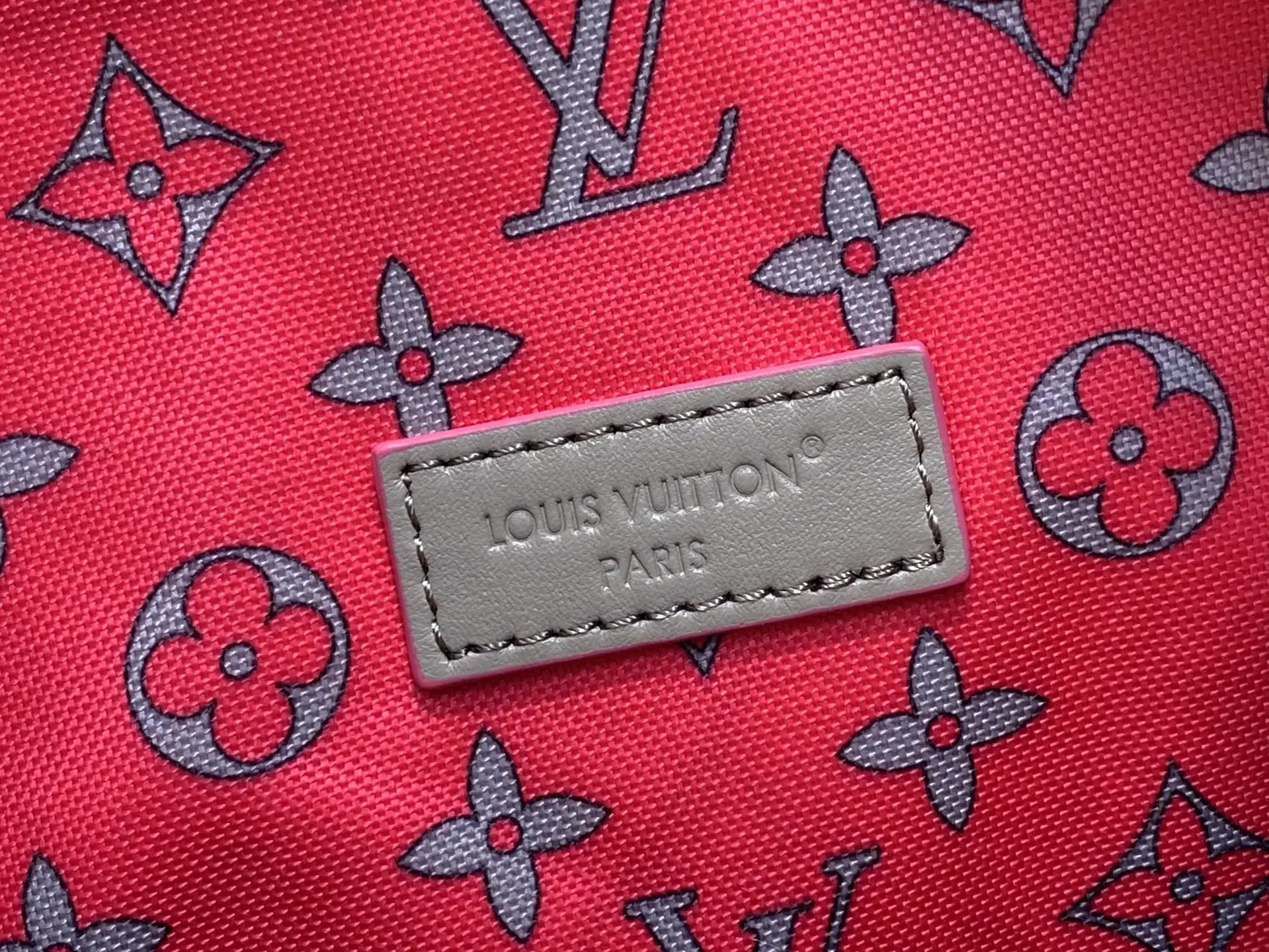Louis Vuitton bag red monogram canvas gray leather logo patch detailed fabric close-up