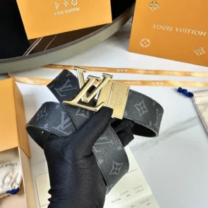 L0UIS VUITT0N Donkey Men's Belt displayed with gold logo buckle on custom canvas, surrounded by branded packaging and accessories.