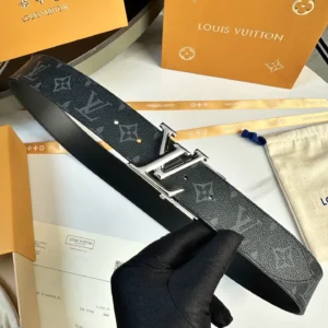 L0UIS VUITT0N Donkey Men's Belt displayed on a surface, featuring the iconic LV monogram pattern, silver buckle, and luxury packaging elements.