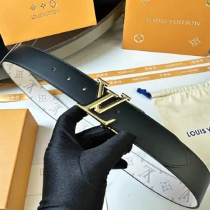 Men's Louis Vuitton Donkey belt featuring a gold LV logo buckle, held in a gloved hand, with packaging elements in the background, highlighting luxury replica accessories.