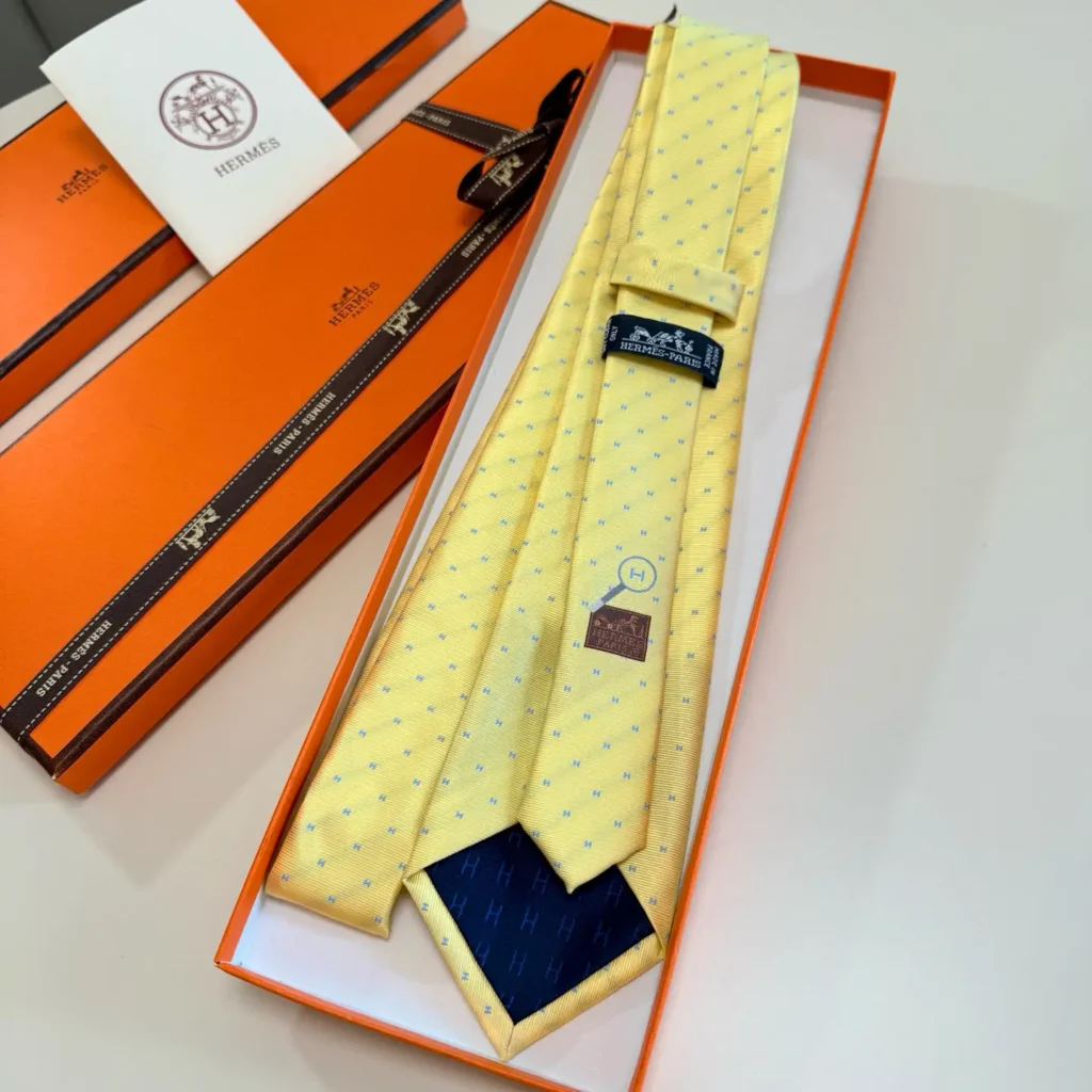 Hermes tie yellow blue polka dot silk necktie with navy H-pattern lining in orange box
