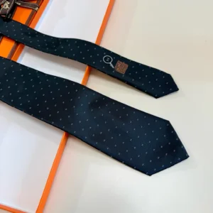 Hermès silk tie navy blue color featuring subtle patterned design and Hermès logo tag