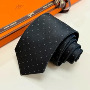 Hermes patterned black silk tie featuring small white H logos and luxury gift box packaging