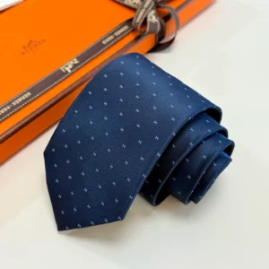 Hermès silk tie navy blue color with subtle H pattern luxury accessory with branded packaging box