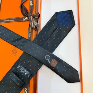 Hermès silk tie black with blue pattern luxury craftsmanship Paris accessory elegant design