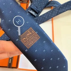 Hermès necktie navy blue silk fabric magnifying glass and logo embroidered pattern luxury accessory