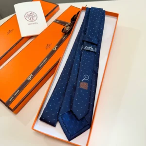 Hermes silk tie navy blue with subtle 'H' pattern and tucked label in orange box packaging
