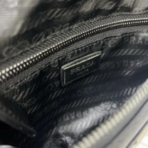 Prada bag black fabric with printed interior lining and metal logo plaque