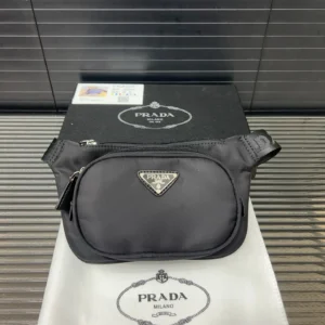 Prada Nylon Waist Bag displayed on a black box with Prada logo, featuring a sleek design and silver hardware, emphasizing luxury and fashion.