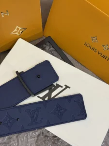 LV Shadow belt in blue leather with embossed monogram pattern, displayed on luxury packaging, highlighting premium quality and brand elegance.