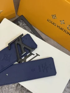 LV Shadow belt with Monogram Shadow, featuring a blue leather design and signature LV logo, displayed on a white surface with Louis Vuitton packaging.