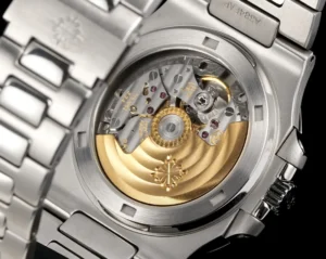 Patek Philippe Nautilus stainless steel watch with transparent case back and gold rotor visible mechanism