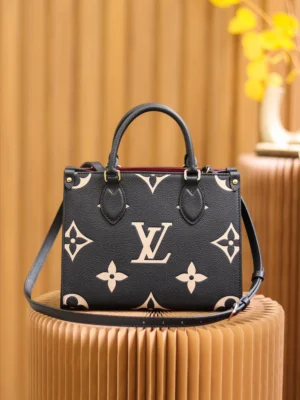 Onthego PM Bicolor Monogram Empreinte Leather Bag by Louis Vuitton in black and beige, featuring iconic logo and floral patterns, displayed on a textured surface with decorative elements in the background.