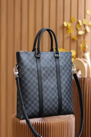 Montaigne BB Monogram canvas handbag in black checkered pattern with dual handles and detachable shoulder strap, displayed against a wooden backdrop.
