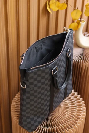 Montaigne BB Monogram canvas handbag featuring a checkered design, open zipper, and dual handles, set against a textured background, highlighting its luxury appeal and functionality.