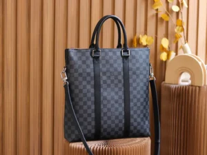 Montaigne BB Monogram canvas handbag in checkered pattern, featuring dual handles and detachable shoulder strap, displayed against a textured background.