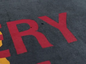 RepsGoat graphic print t-shirt dark gray cotton material close-up texture shot