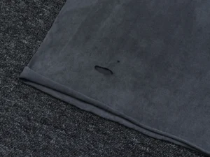 Repsgoat black distressed cotton t-shirt with a small hole detail near the hem