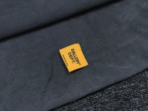 Gallery Dept. clothing black cotton fabric with yellow brand label sewn on