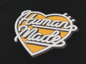 Human Made graphic print black cotton t-shirt with yellow heart and white script design