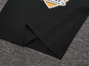 Repsgoat black cotton t-shirt soft fabric casual wear close-up on textured grey surface