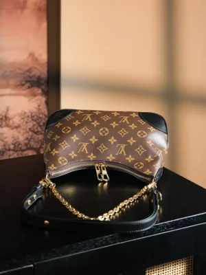 Louis Vuitton Dhanura PM Brown monogram canvas bag with black leather trim and gold chain strap